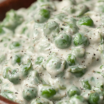 Bowl of creamed peas in buttery sauce