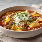 steaming cheesy lasagna soup with ricotta basil and tomato broth