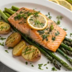 Crispy Baked Salmon fillets with lemon slices and fresh herbs