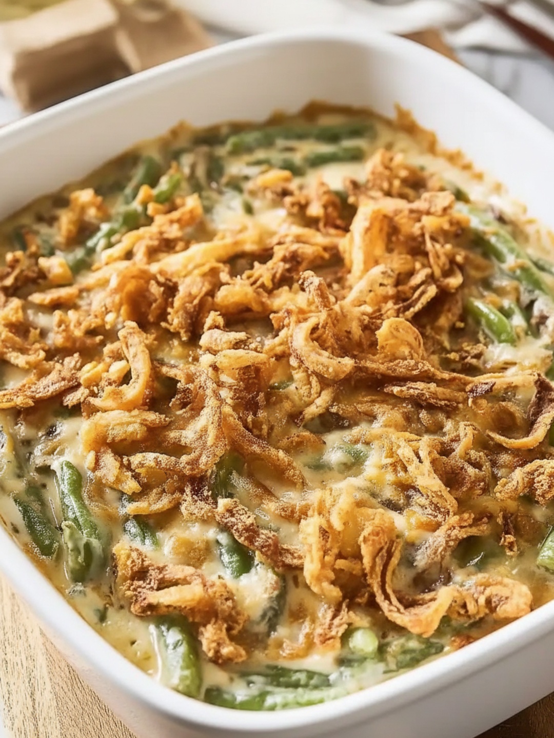 A classic Campbells Green Bean Casserole fresh out of the oven, topped with golden fried onions.