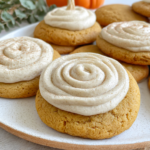 Soft pumpkin cookies with cinnamon frosting on a cooling rack