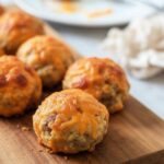 Close-up of Bisquick sausage balls on a matte ceramic plate