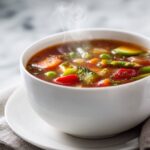 Easy Vegetable Soup Recipe (Healthy, Cozy, Winter Comfort Food) in a white bowl with colorful vegetables
