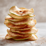 Close-up macro shot of a crisp apple chip held up.