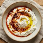Chili crisp Greek yogurt dip with chili oil swirl