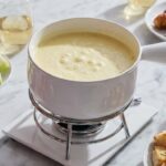 Gruyere cheese fondue served warm with bread dippers