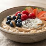 Healthy breakfast bowl with oatmeal, yogurt, fresh fruit, and seeds