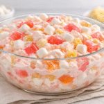 Classic jello and marshmallow fluff salad with pastel gelatin cubes and mini marshmallows in glass bowl