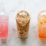 Three 7 Brew drinks to try including energy drink, iced latte, and fizz drink on marble
