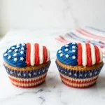 USA flag cupcakes with red white and blue buttercream stripes and pearl star sprinkles