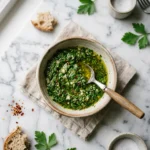 Bowl of authentic chimichurri sauce recipe on marble